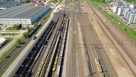 Flying-above-industrial-railroad-station-with-cargo-trains-and-freight-containers