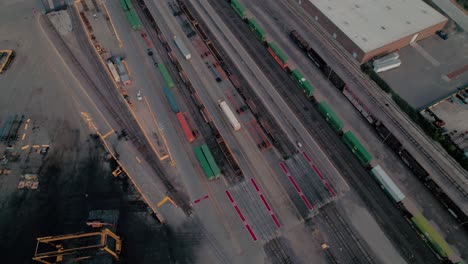 yard-jockey-trucks-driving-with-trailers-in-a-Intermodal-Terminal-Rail-road-with-yard-full-of-containers-with-Chicago-in-background