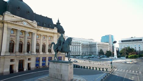 Rotating-Aerial-View-Of-King-Carol-I-of-Romania-Statue-in-Front-Of-The-Central-University-Library-On-Calea-Victoriei-Avenue,-Bucharest