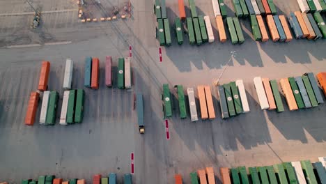 yard-jockey-truck-driving-with-container-in-a-Intermodal-Terminal-Rail-road-with-yard-full-of-containers