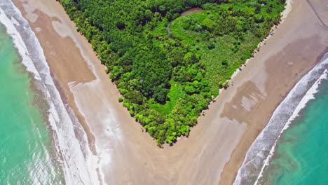 Aerial-drone-footage-revealing-a-beach-shaped-like-a-whale's-tail-in-Ballena-Marine-National-Park,-Costa-Rica
