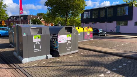 Public-waste-bins-on-Amsterdam-parking-lot-in-Vogelbuurt-during-hot-summer