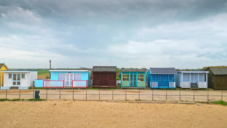 Bird's-eye-view-of-Mablethorpe's-east-coast-beauty,-with-beach-huts,-sandy-beaches,-amusement-parks,-rides,-and-the-vibrant-tourist-presence
