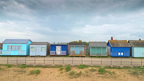 Aerial-scenes-capture-Mablethorpe's-essence,-featuring-beach-huts,-sandy-beaches,-amusement-parks,-rides,-and-the-lively-tourist-scene