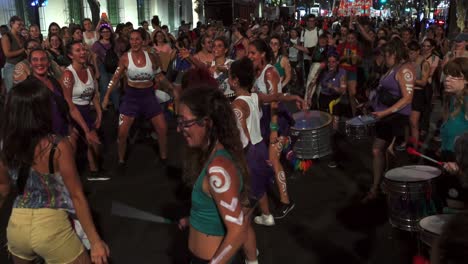 Feminist-young-women-dance-happy-with-painted-bodies-in-drum-circle,-peaceful-protest-against-patriarchy