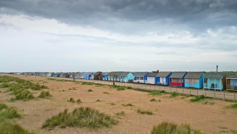 Witness-the-coastal-allure-of-Mablethorpe-through-aerial-footage,-highlighting-beach-huts,-sandy-beaches,-and-vibrant-amusements