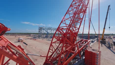Fpv-drone-flight-around-construction-site-with-cranes-during-building-phase-of-thermoelectric-power-plant-on-Dominican-republic