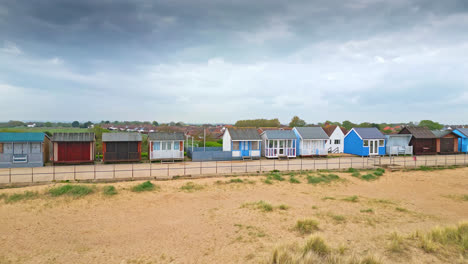Marvel-at-Mablethorpe's-beauty-from-the-air,-a-Lincolnshire-seaside-gem,-spotlighting-beach-huts,-sandy-beaches,-and-the-bustling-amusement-parks-with-tourists