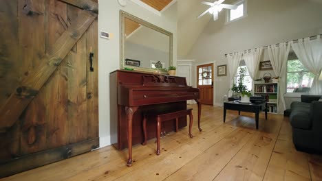 A-push-in-shot-of-an-old-wooden-piano-in-the-living-room-of-a-farm-house