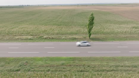Cars-Driving-In-The-Highway-Passing-By-On-The-Romanian-Fields-In-Daytime