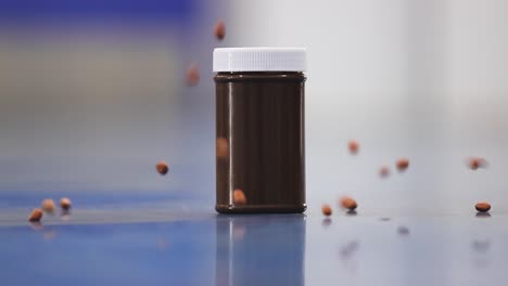 Slow-motion-scene,-best-quality-raw-peanut-kernels-falling-around-a-bottle-of-chocolate-flavor-peanut-butter-in-selective-focus-in-slow-motion