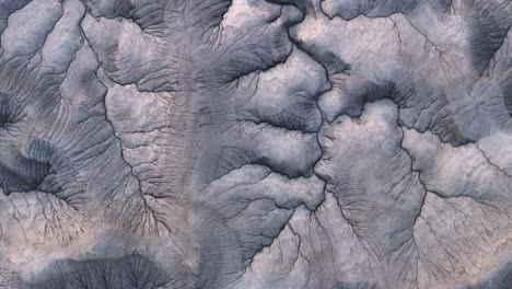 Surface-background,-far-away-planet-with-cracks-and-river-beds,-top-down-aerial