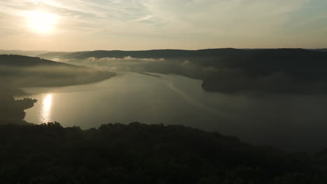 Silhouette-Of-Vegetation-Surrounding-Lake-Fort-Smith-At-Dawn-In-Arkansas,-USA---aerial-shot