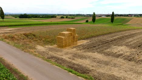 Stacked-Square-Hay-Bales-In-Vast-Rural-Farmland