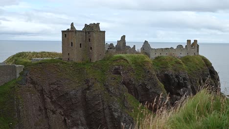 Looking-from-the-cliff-towards-Dunnottar-Castle,-Scotland,-United-Kingdom
