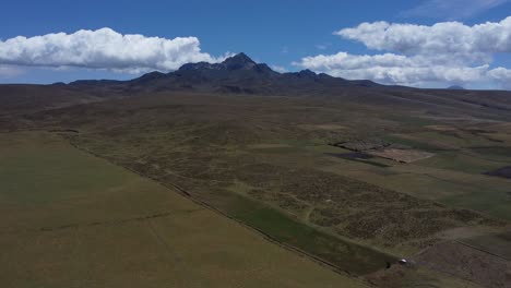 Embark-on-a-breathtaking-4K-drone-journey-through-Ecuador's-mystical-highlands,-capturing-the-tranquil-expanse-of-páramo-landscapes-and-drawing-closer-to-the-majestic-Rumiñahui-Volcano
