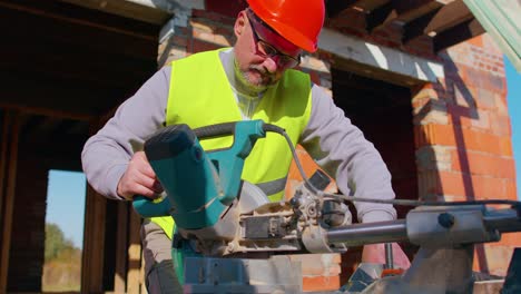 Carpenter-man-using-circular-electric-saw-for-cutting-wooden-boards,-woodworker-at-construction-site