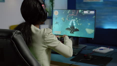 Back-shot-of-pro-black-woman-streamer-winning-graphics-cyber-space-shooter