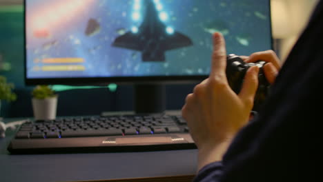 Close-up-of-professional-cyber-gamer-playing-space-shooter-video-game
