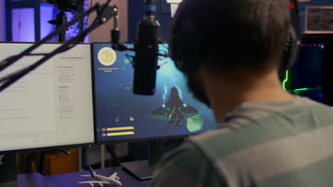 Back-shot-of-streamer-man-playing-on-powerful-computer