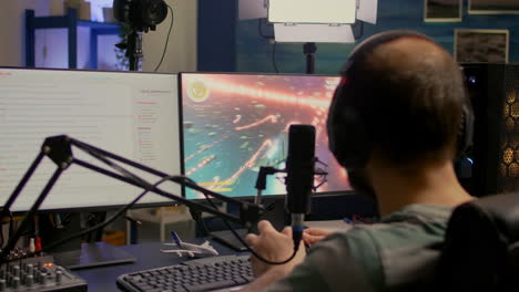 Streamer-with-headphone-losing-space-shooter-game-competition-using-modern-equipment