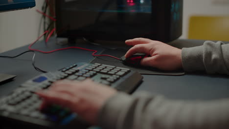 Close-up-hands-shot-of-man-player-typing-on-RGB-keyboard