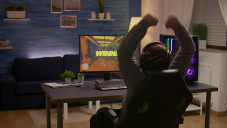 Videogamer-player-raising-hands-after-winning