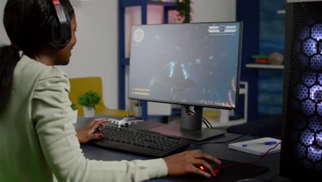 Pro-black-woman-gamer-playing-space-shooter-videogame
