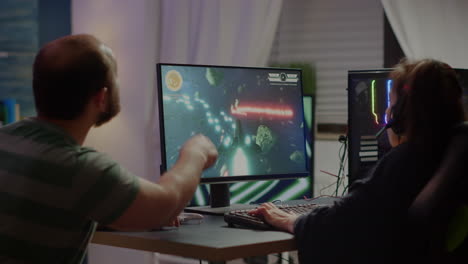Gaming-over-for-nervous-pro-couple-gamers,-playing-space-shooter