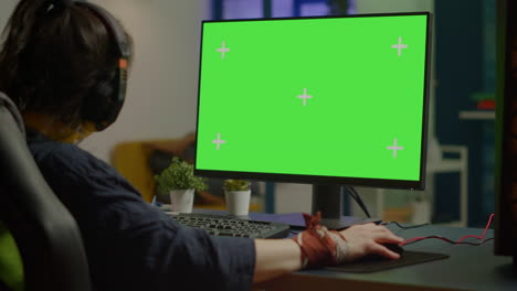 Woman-streaming-online-video-games-on-powerful-computer-with-green-screen