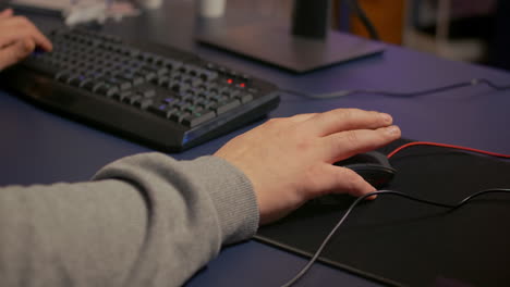 Close-up-on-hands-of-player-man-using-professional-RGB-mouse