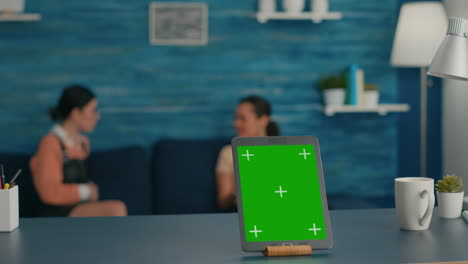 Isolated-tablet-computer-with-mock-up-green-screen-chroma-key-standing-on-desk-table