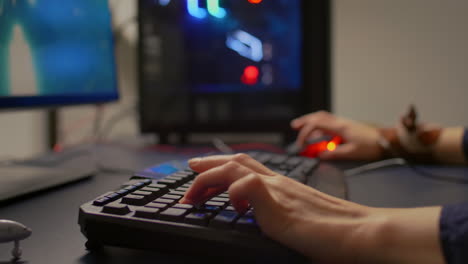 Close-up-of-gamer-using-RGB-keyboard-and-mouse