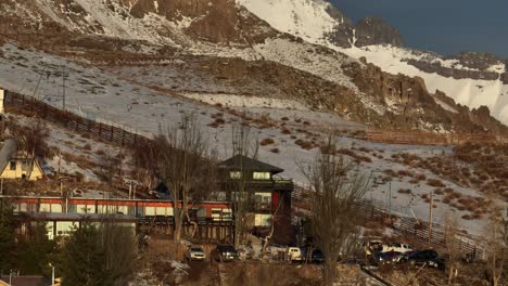Aerial-rotating-shot-of-a-small-apartment-located-at-the-base-of-a-ski-run-in-Chile