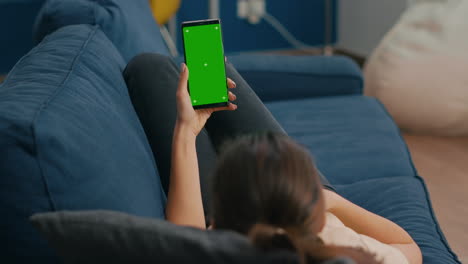Freelancer-lying-on-sofa-while-having-online-videocall-on-smartphone