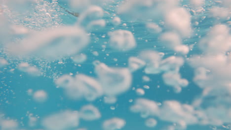 Cinematic-underwater-slow-motion-shot-of-air-bubbles-in-clear-blue-waters-in-4K,-120FPS,-Slomo