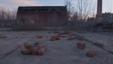 red-bricks-litter-the-ground-in-front-of-abandoned-industrial-buildings