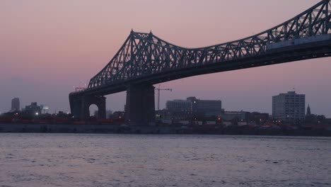 The-Jacques-Cartier-Bridge-and-the-Port-of-Montreal-in-Quebec-at-Sunset-on-a-Beautiful-Evening-from-Across-the-St