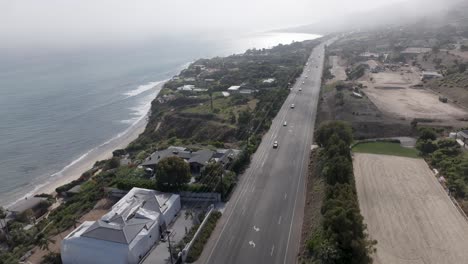 A-foggy,-misty-morning-over-the-famous-and-scenic-Pacific-Coast-Highway---aerial-flyover