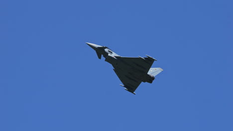 German-Eurofighter-Typhoon-against-blue-sky,-follow-view