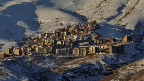 Aerial-orbiting-shot-of-the-El-Colorado-Ski-Resort-within-the-Andes-during-sunset
