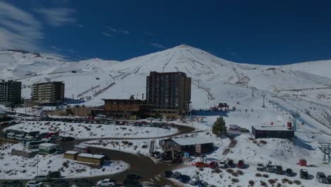 Aerial-rotating-shot-of-a-ski-resort-hotel-at-the-base-of-the-El-Colorado-slopes