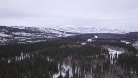 Slow-Aerial-Wide-Pushin-Across-Alaska-Wilderness-in-the-Winter,-Chena-Hot-Springs-Road
