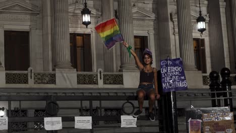 Handheld-shot-of-teenager-activist-holding-LGBTQ-rainbow-pride-flag