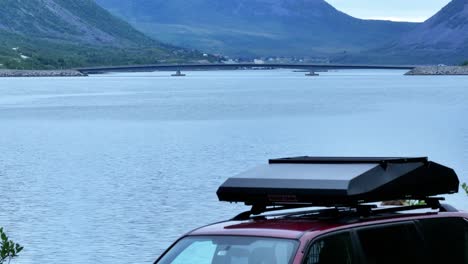Camping-Vehicle-Parked-By-The-Shore-Of-Gryllefjord-With-View-Of-Gryllefjord-Bridge-In-Senja,-Norway