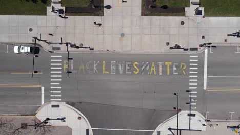 Black-Lives-Matter-painted-onto-road-in-front-of-the-Michigan-State-Capital,-aerial-top-down-view