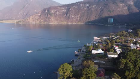 Aerial-tilts-down:-Jaibalito-village-on-Lake-Atitlan-shore,-Guatemala