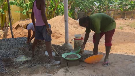 A-labourer-manually-mixing-cement-with-a-spade