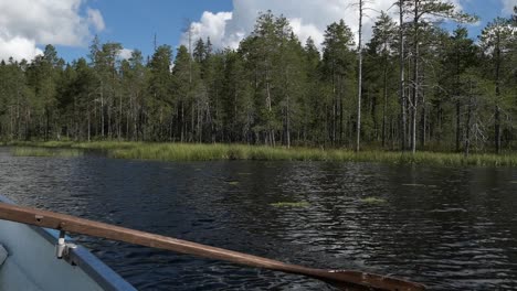 Boat-rowing-in-lake-calm-water,-Finland