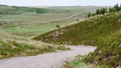 Shot-of-a-gravel-road-with-a-peat-bank-and-moor